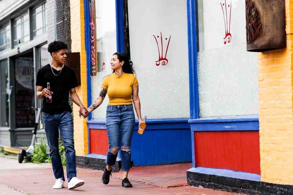 man in yellow crew neck t-shirt standing beside woman in black t-shirt