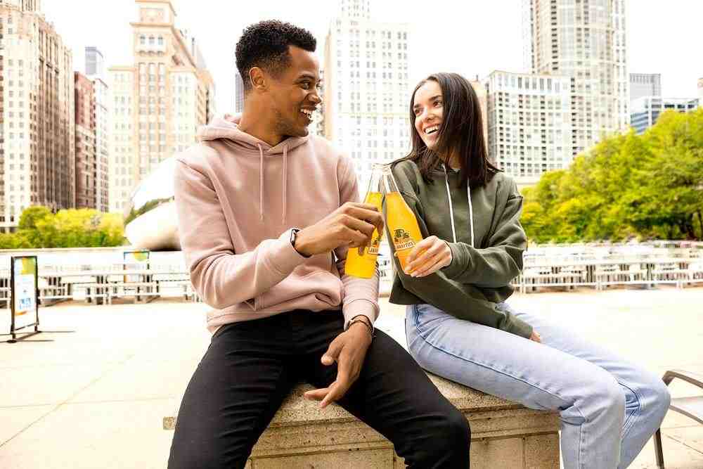 man in gray hoodie sitting beside woman in gray jacket