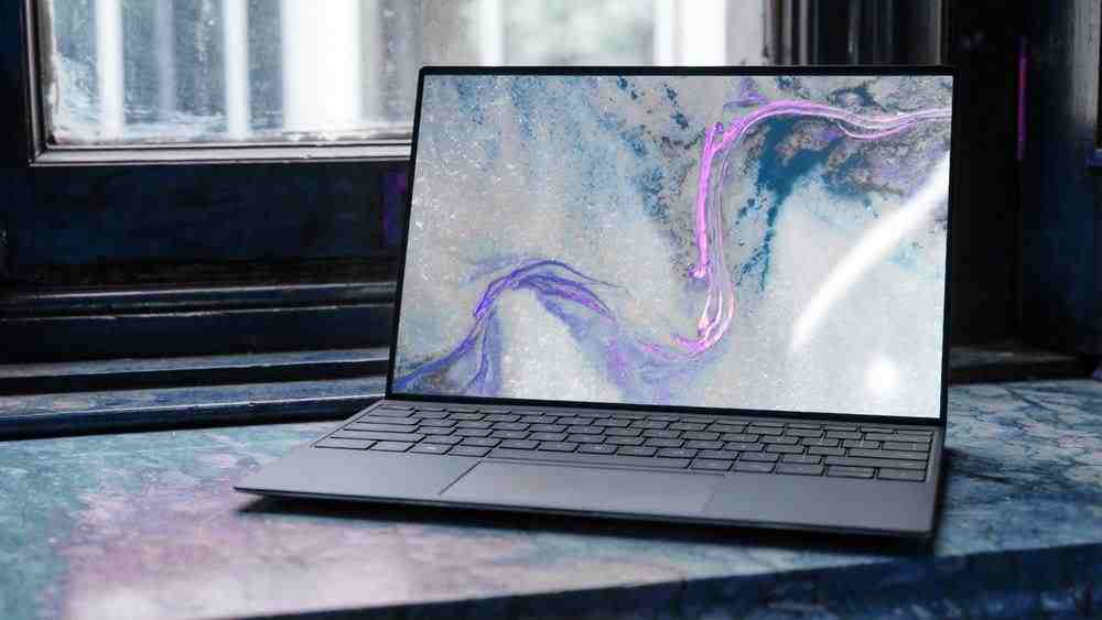 laptop on brown wooden table